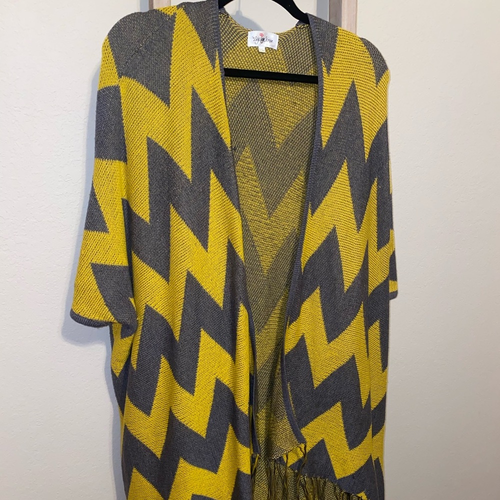 Cardigan/poncho with fringe on the ends